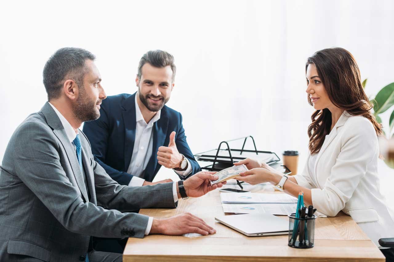 Handsome investor giving dollar banknotes to beaut 2024 11 18 11 23 55 utc2.jpg